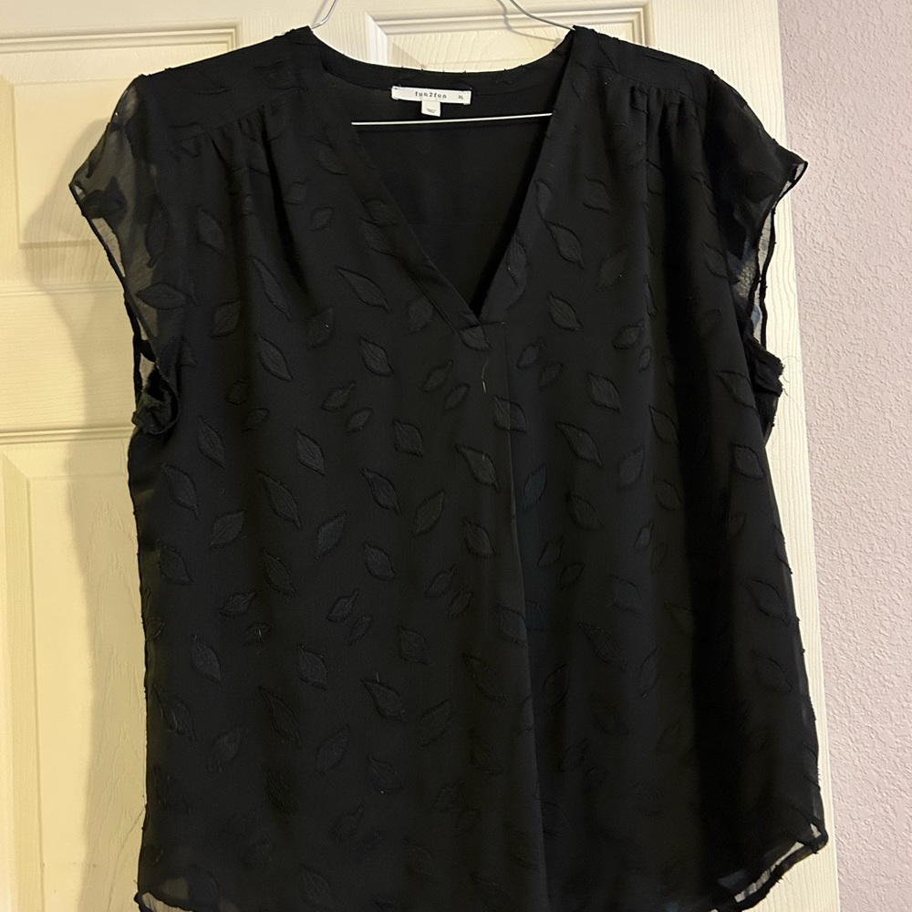 Black shirt. Looks great under blazer.